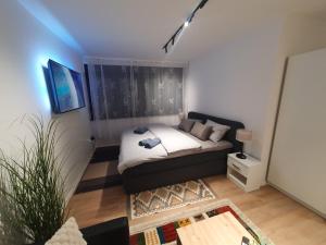 a small living room with a bed and a couch at Sofia Apartment free parking in Sarajevo