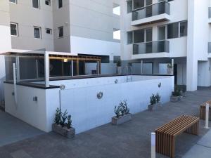a building with a bar in the middle of a courtyard at Torre 2 in Puerto Madryn +3 photos