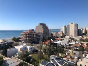 a view of a city with buildings and the ocean at Torre 2 in Puerto Madryn