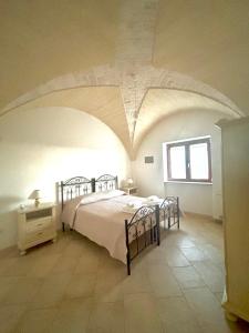 a bedroom with a bed and a window in a room at Iannuzzi Casa Vacanze in Locorotondo +5 photos