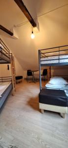 a room with two bunk beds and a table and chairs at Princessen på ærten in Odense +61 photos