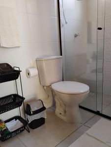 a bathroom with a toilet and a shower at Hospedagem Alecrim in Santo Amaro da Imperatriz