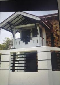 a front view of a house with a balcony at Villa J&T in Katunayake