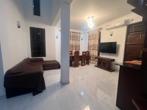 a bedroom with a bed and a television in a room at Villa J&T in Katunayake