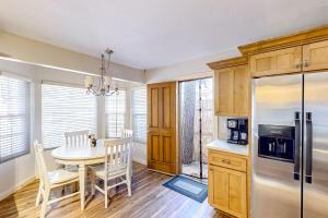 a kitchen and dining room with a table and a refrigerator at Sugarloafing ~ Dog-friendly cabin with hot tub, covered porch, fireplace, grill, & W/D in Sugarloaf +11 photos