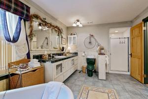 a large bathroom with a tub and a sink at Rooster's Den ~ Charming house with expansive deck, cable, internet, near Big Bear Lake in Big Bear Lake +17 photos