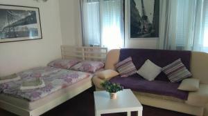 a bed and a couch in a room at Apartments Paradiso in Samobor