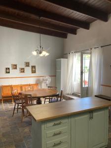 a kitchen and dining room with a table and chairs at Quaint Karoo in Graaff-Reinet