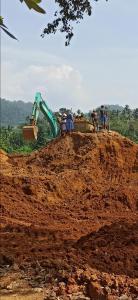 a bulldozer on top of a dirt hill with people at 4Seasons Holiday Home in Ratnapura +34 photos