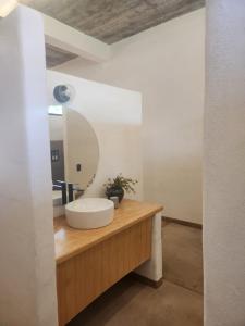 a bathroom with a sink and a mirror on a counter at Casa Nuestra Hotel Boutique y Experiencias para Compartir in Malinalco +19 photos