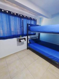 two bunk beds in a room with blue walls at Neza Esperanza in Ciudad Nezahualcóyotl +64 photos