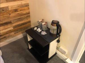 a black table with a coffee maker on it at 106 Brynmill - Room 3 in Sketty