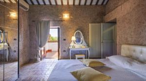 a bedroom with a large bed and a mirror at Villa Denise in Mancini +15 photos