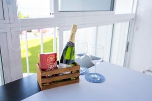 a bottle of wine and two glasses on a table at Costa Libertad, Mesa del mar in Tacoronte