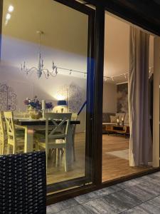 a dining room with a table and a glass window at Moja bajka in Zamość