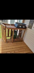 a picnic table with a grill on a deck at Mobil-home 3 chambres 6 personnes in Saint-Hilaire-de-Riez