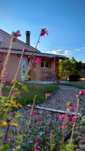 a house with pink flowers in front of it at Le Gîte de Cousal in Esperce +16 photos