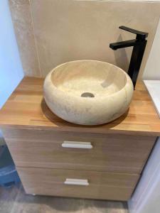 a stone sink sitting on top of a wooden dresser at Cosy T2 Terrasse Hyper Centre in Bourges +33 photos