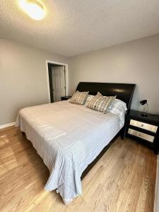 a bedroom with a large bed with a white comforter at 2Bed 2Bath Cozy Apartment off Guilford college! in Greensboro +24 photos