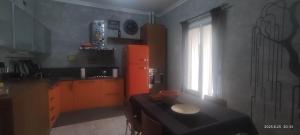 a kitchen with an orange refrigerator and a window at La casa di Betta in Lerici