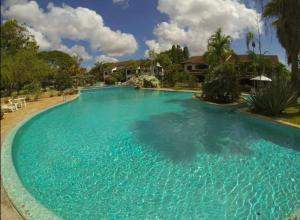 a large swimming pool with blue water at Woburn Apartments 5C in Malindi