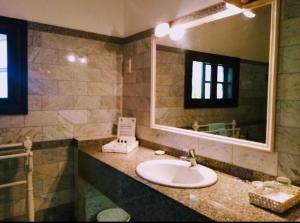 a bathroom with a sink and a mirror at Woburn Apartments 5C in Malindi
