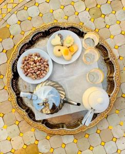a table with plates of food and bowls of food at ChariF Luxury Camp in Rissani