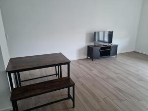 a living room with a table and a tv at Monteurwohnung Pforzheim mit Balkon - QuartierPro in Pforzheim