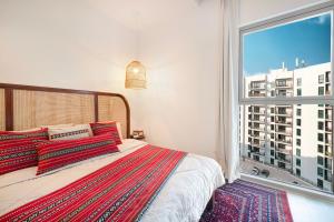 a bedroom with a bed and a large window at 1BR Yas Marina Apartment - Near Ferrari World in Abu Dhabi