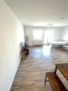 a living room with a bench and a table at Monteurwohnung Pforzheim mit Balkon - QuartierPro in Pforzheim