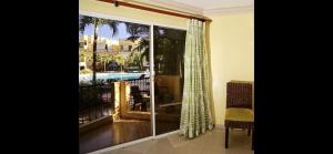 a sliding glass door with a view of a pool at Garden condos, unit#8 in Sosúa