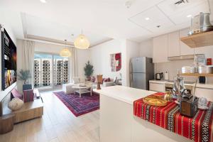 a kitchen and living room with a refrigerator and a counter at 1BR Yas Marina Apartment - Near Ferrari World in Abu Dhabi