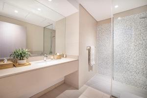 a bathroom with a sink and a shower at 1BR Yas Marina Apartment - Near Ferrari World in Abu Dhabi +42 photos