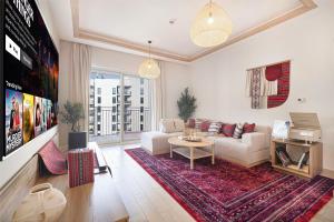 a living room with a couch and a table at 1BR Yas Marina Apartment - Near Ferrari World in Abu Dhabi