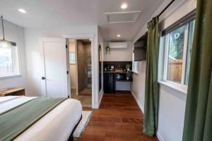 a bedroom with a large bed and a kitchen at Columbia Cabins Cabin 4 in Sonora