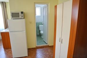 a kitchen with a refrigerator and a microwave at Zlatna Ribka in Chernomorets +82 photos