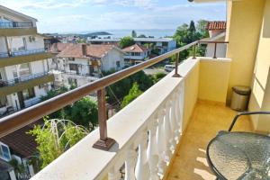 a balcony with a table and a view of a city at Zlatna Ribka in Chernomorets
