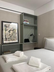 a bedroom with a bed with two pillows on it at Green & Grey Loft in Matosinhos
