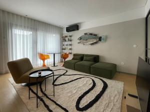 a living room with a couch and a table at Green & Grey Loft in Matosinhos