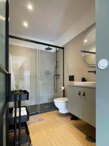 a bathroom with a shower and a toilet and a sink at Green & Grey Loft in Matosinhos +16 photos
