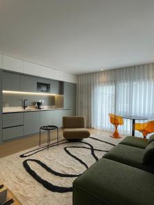 a living room with a couch and a table at Green & Grey Loft in Matosinhos