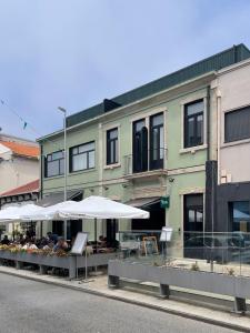 a building with umbrellas on the side of the street at Green & Grey Loft in Matosinhos