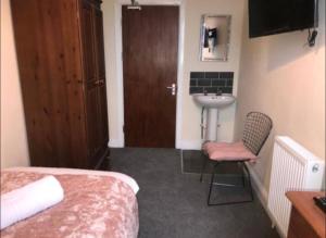 a hotel room with a bed and a sink at 106 Brynmill - Room 6 - Sea views in Sketty