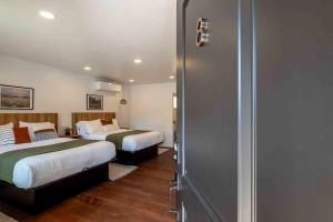 a hotel room with two beds and a closet at Columbia Cabins Cabin 8 in Sonora