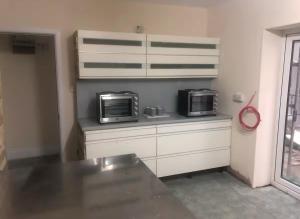 a kitchen with two microwaves sitting on a counter at 106 Brynmill - Room 7 in Sketty +5 photos