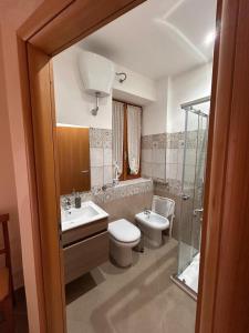a bathroom with a toilet and a sink and a shower at B&B Il Cuore del Borgo in Papasidero +20 photos