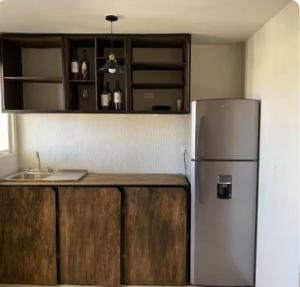 una cocina con refrigerador y encimera en Habitación para descansar, en Tijuana