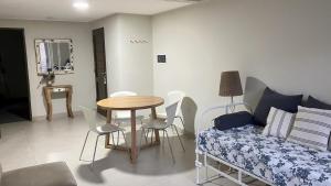 a living room with a table and a couch at Rincón de Barrio Sur in San Miguel de Tucumán