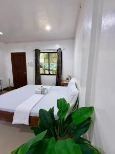 Postel nebo postele na pokoji v ubytování DRB Siargao Apartments