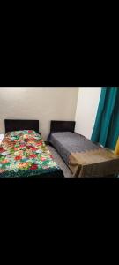 a bedroom with a bed with a colorful quilt at Al Muqtadir girls hostel in Islamabad